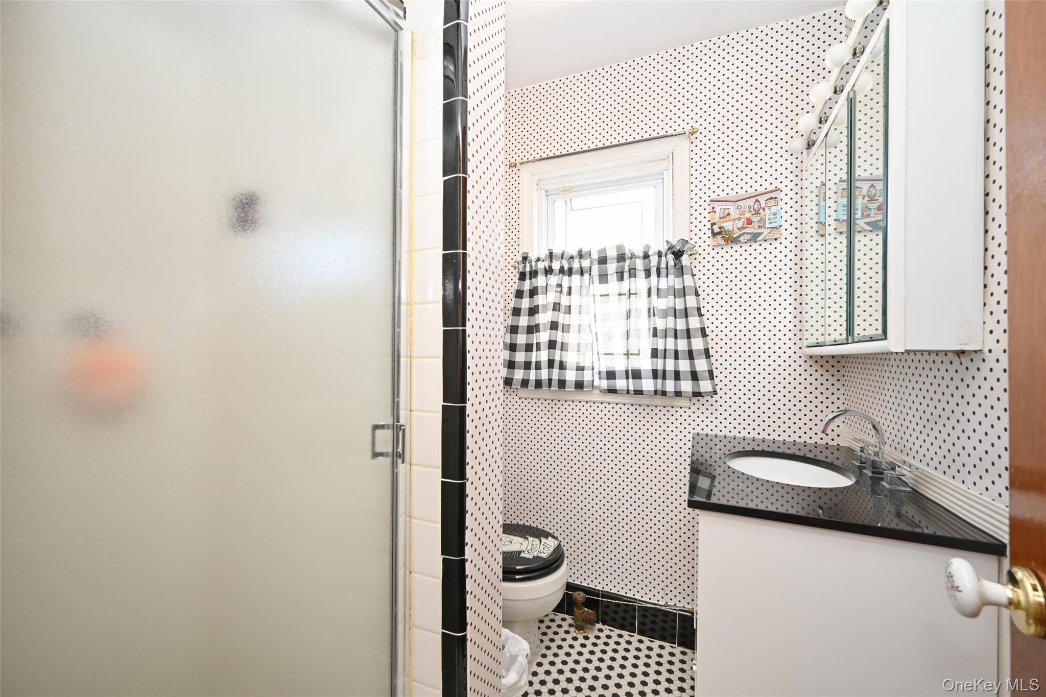 45-18 166th Street Queens, NY 11358 - Photo 16 of 20 a bathroom with a granite countertop sink a toilet and a shower