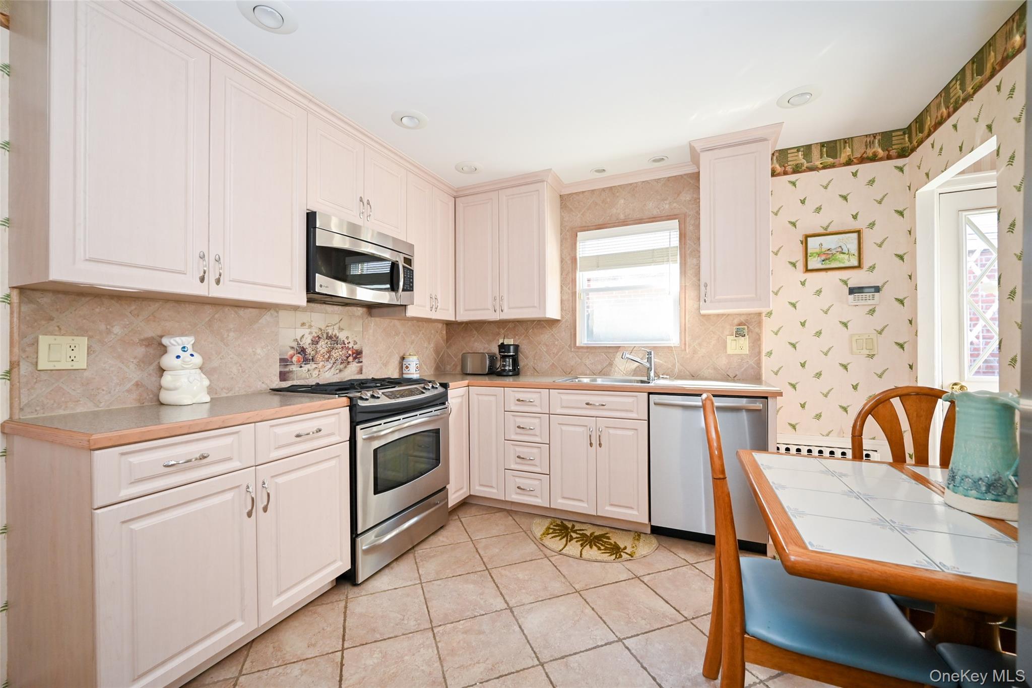 45-18 166th Street Queens, NY 11358 - Photo 4 of 20 a kitchen with granite countertop white cabinets and white appliances