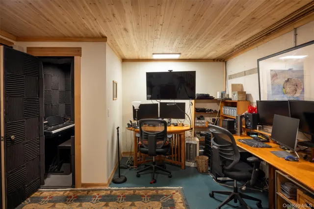 a view of a patio with couches and chairs under an umbrella