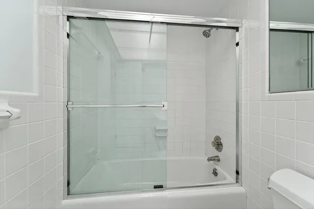 a bathroom with a shower and a bath tub