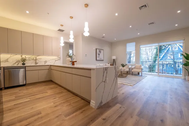 a large white kitchen with a large window