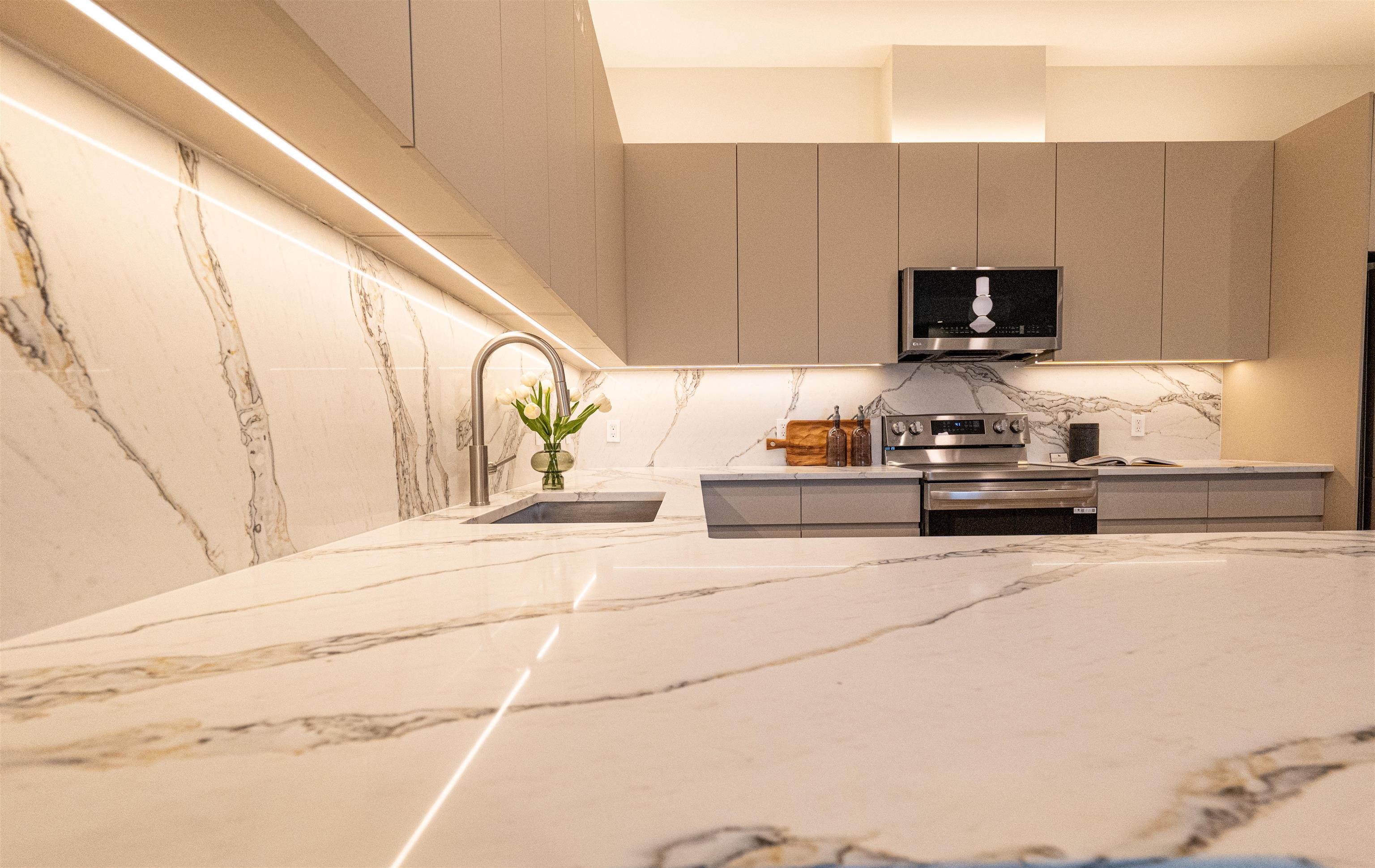 1722 Springfield Avenue, Unit 406 Maplewood, NJ 07040 - Photo 5 of 30 a kitchen with stainless steel appliances kitchen island granite countertop a sink a stove and a microwave