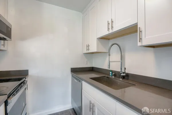 a kitchen with a sink and cabinets