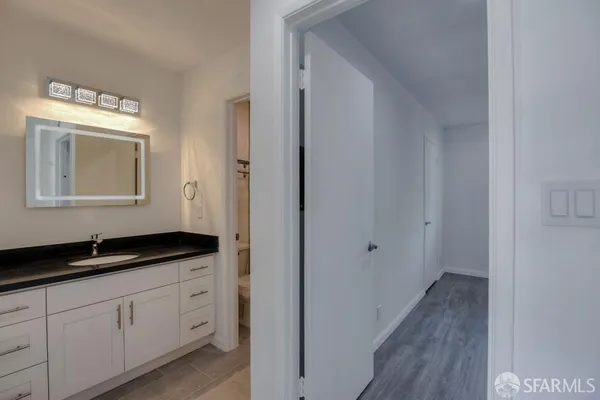 a kitchen with a granite countertop sink and cabinets