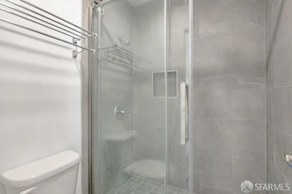 a bathroom with a shower and toilet