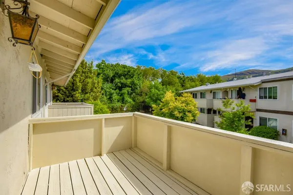 a view of a balcony with wooden floor