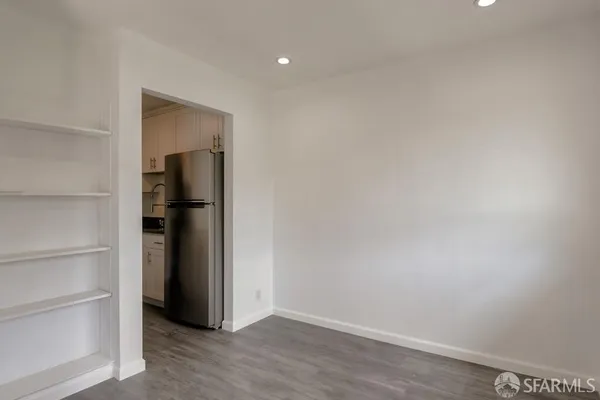 a view of an empty room with closet and a window
