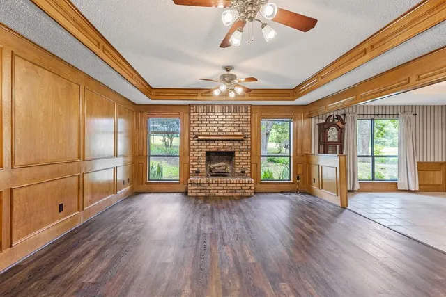a spacious bedroom with a bed and a chandelier