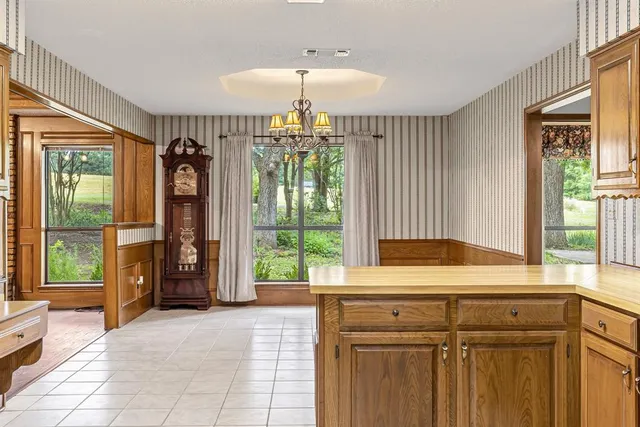 a living room with stainless steel appliances granite countertop furniture and a kitchen view