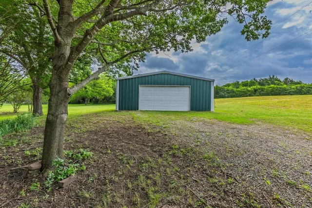 a view of a livingroom with furniture and a window