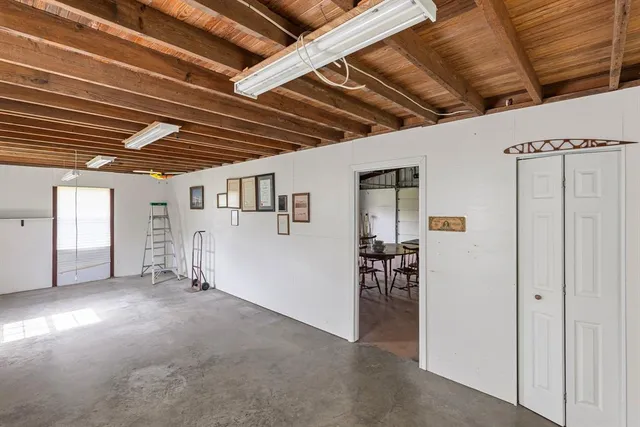 a green field with some trees in the background