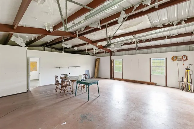 a view of a garden with a bench in the background