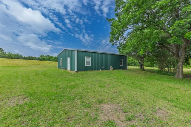 a yellow house in middle of the forest