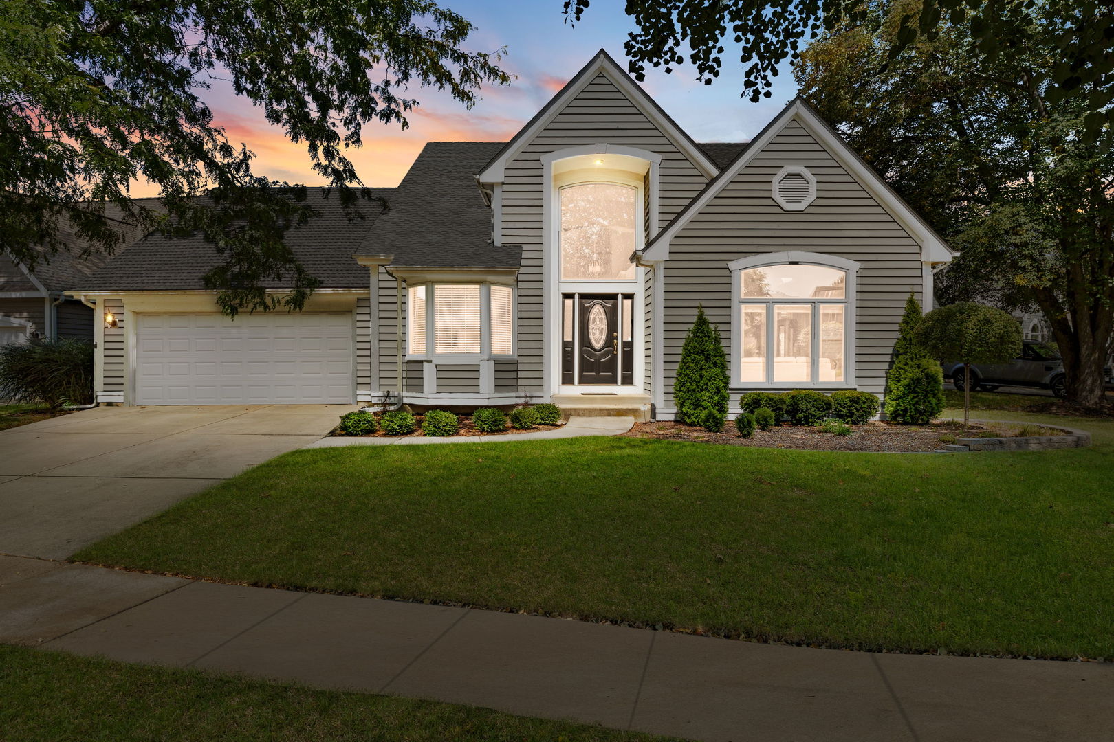 Undisclosed Address Aurora, IL 60502 - Photo 2 of 2 a front view of a house with a yard and trees