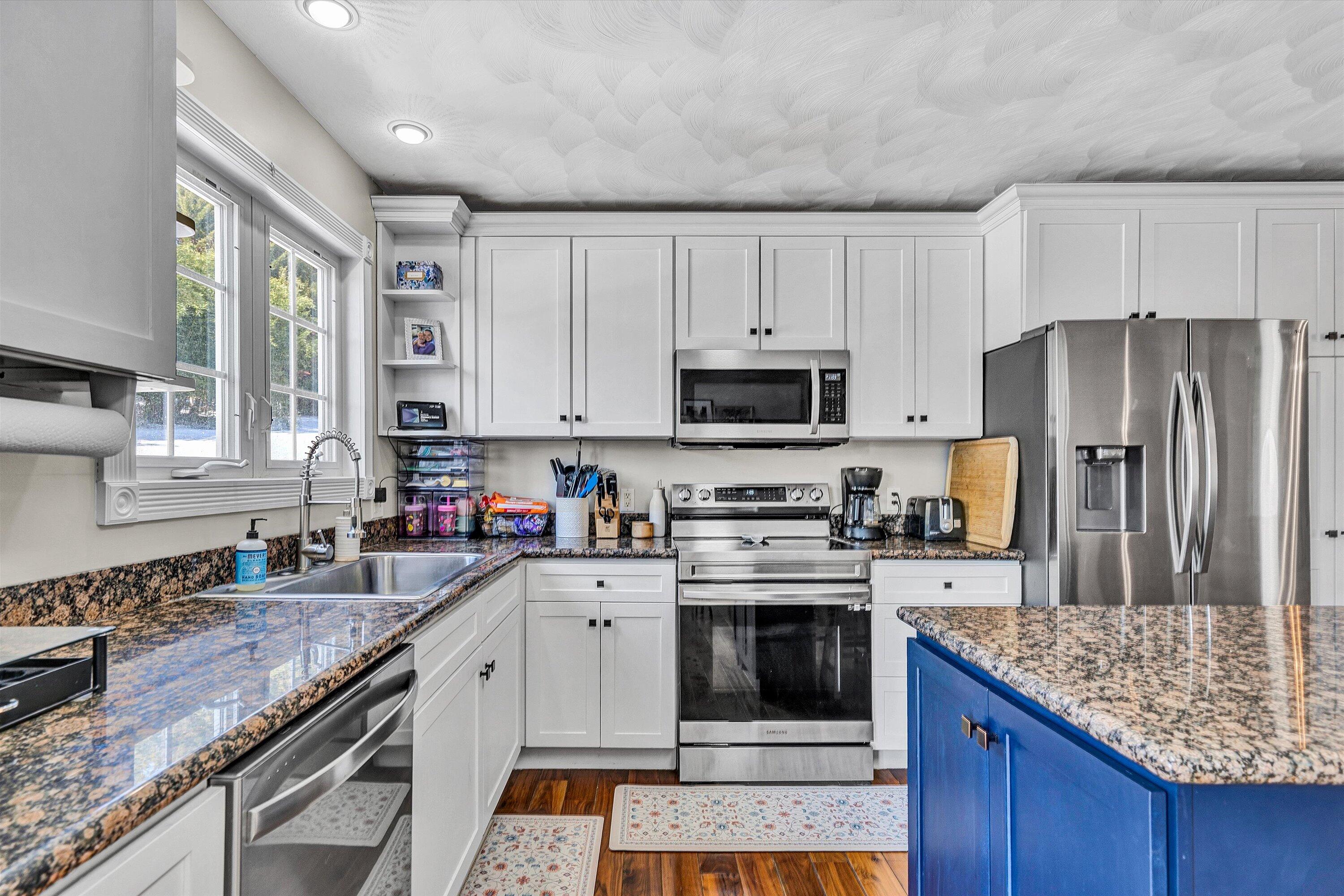 409 Wills Road Lexington, VA 24450 - Photo 14 of 42 a kitchen with stainless steel appliances granite countertop a stove top oven a sink dishwasher and a refrigerator