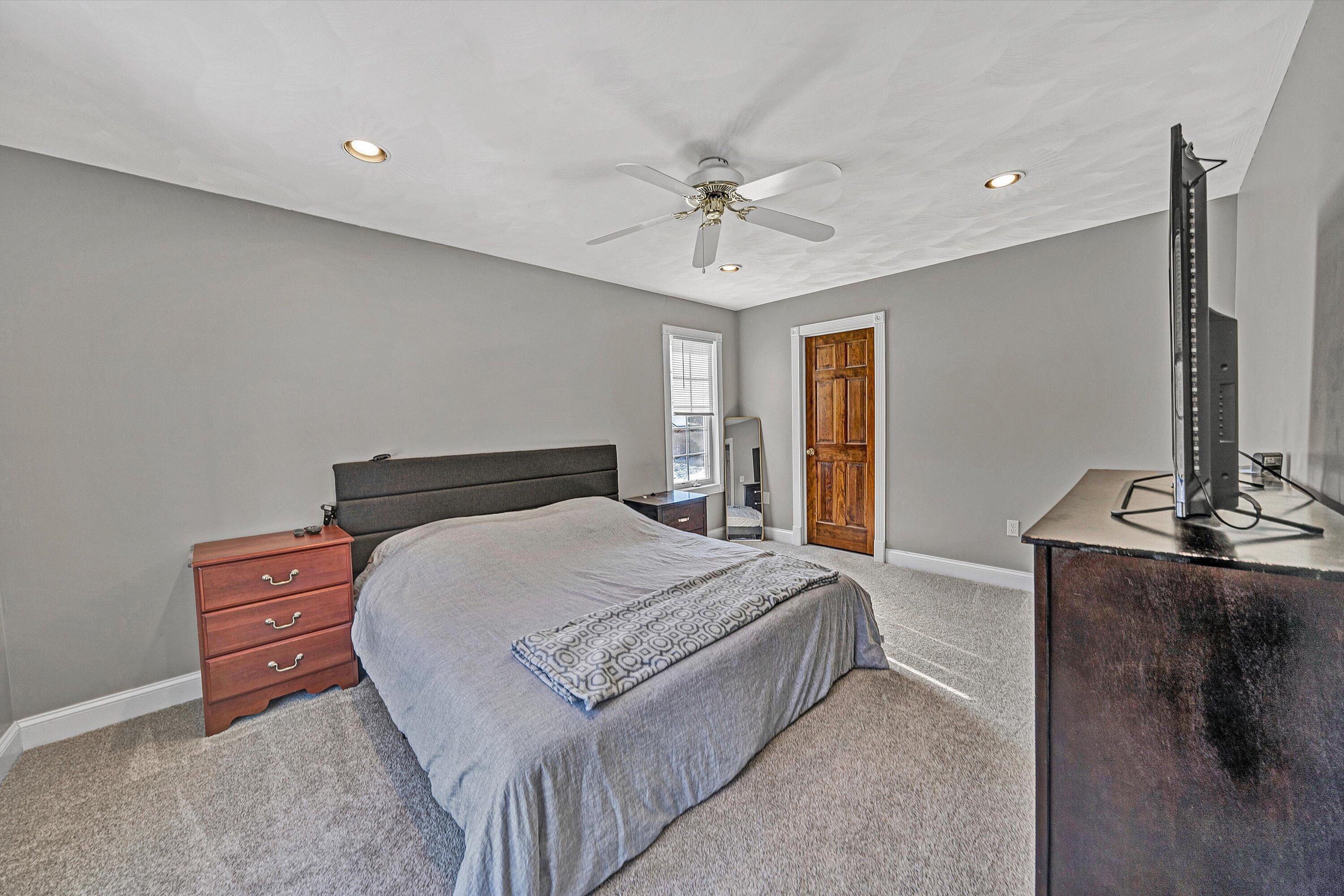 409 Wills Road Lexington, VA 24450 - Photo 21 of 42 a bedroom with a bed and dresser with mirror
