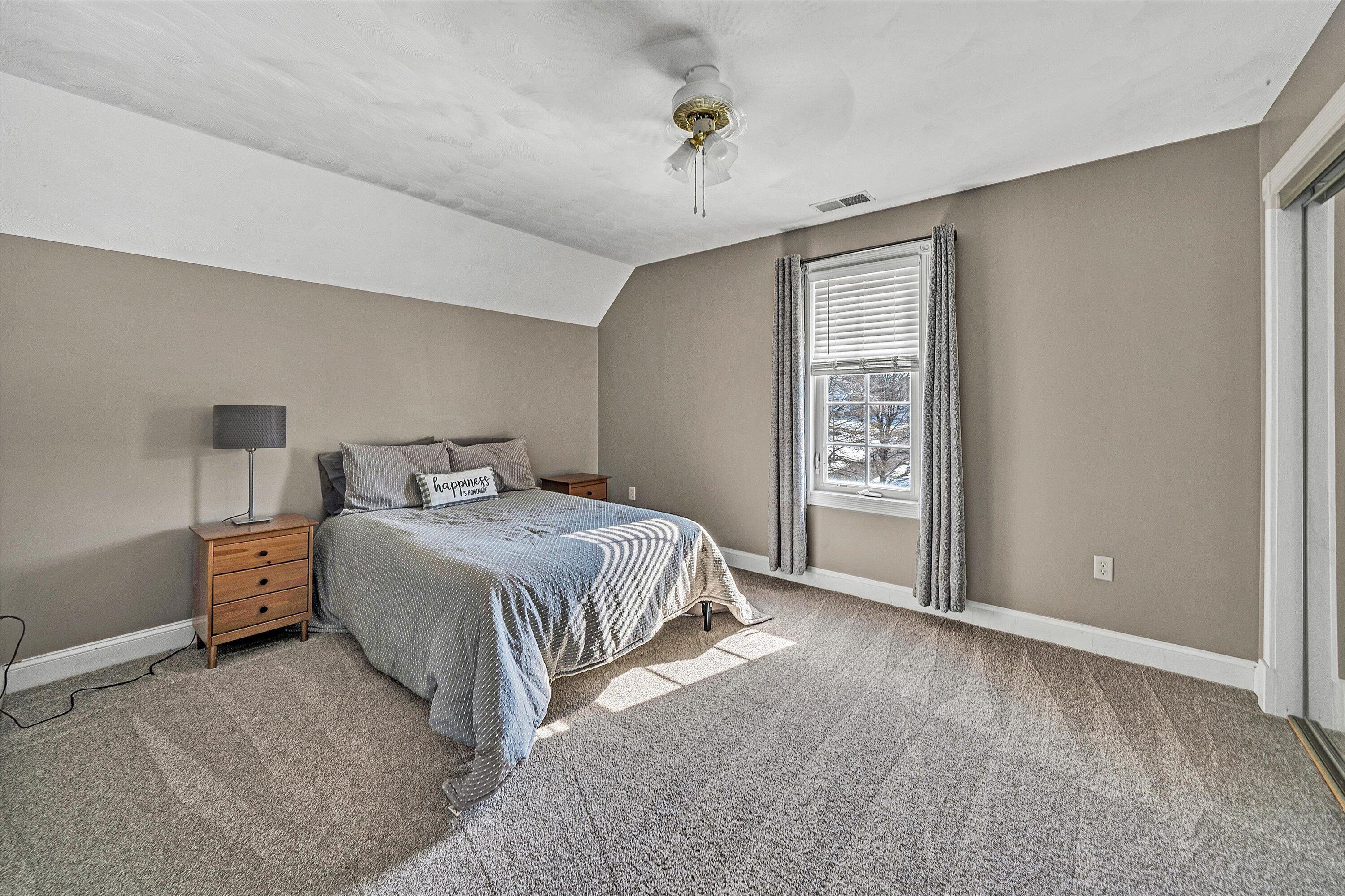 409 Wills Road Lexington, VA 24450 - Photo 29 of 42 a spacious bedroom with a bed and a window