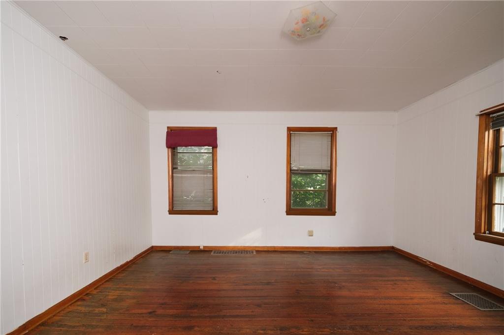 1286 Highway 30 Clinton, PA 15026 - Photo 12 of 23 an empty room with wooden floor and windows