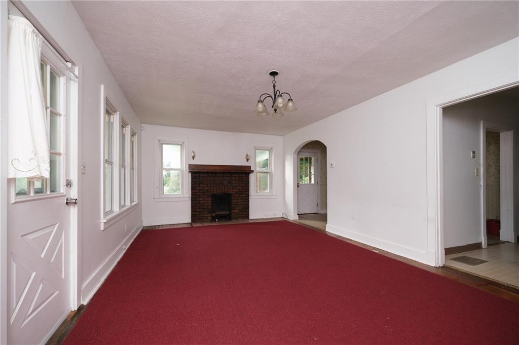 1286 Highway 30 Clinton, PA 15026 - Photo 2 of 23 a view of an empty room with a fireplace and a window