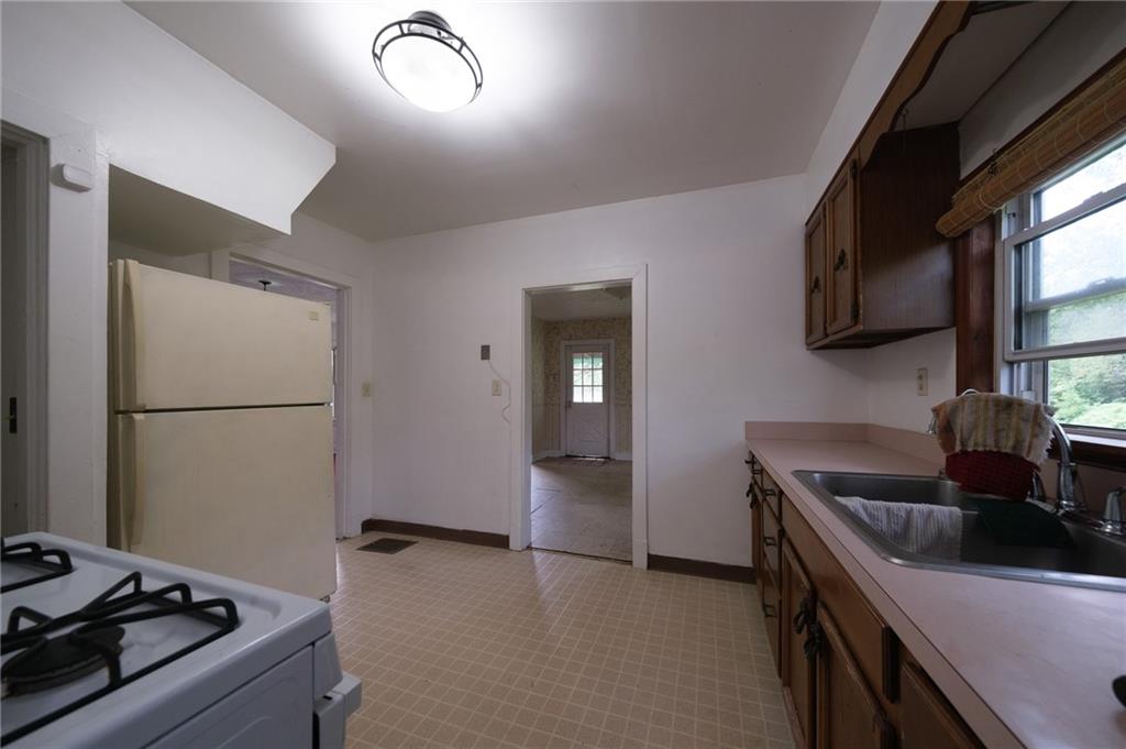1286 Highway 30 Clinton, PA 15026 - Photo 7 of 23 a kitchen with a sink and a refrigerator