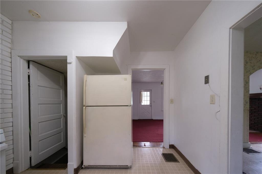 1286 Highway 30 Clinton, PA 15026 - Photo 9 of 23 a view of storage and utility room with refrigerator and wooden floor