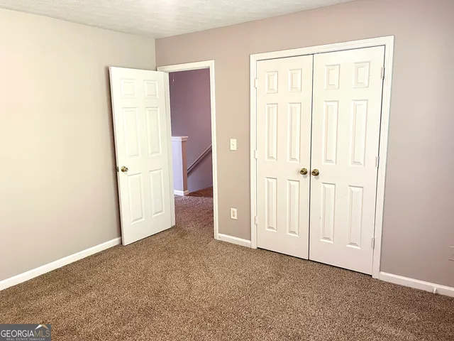 an empty room with closet area