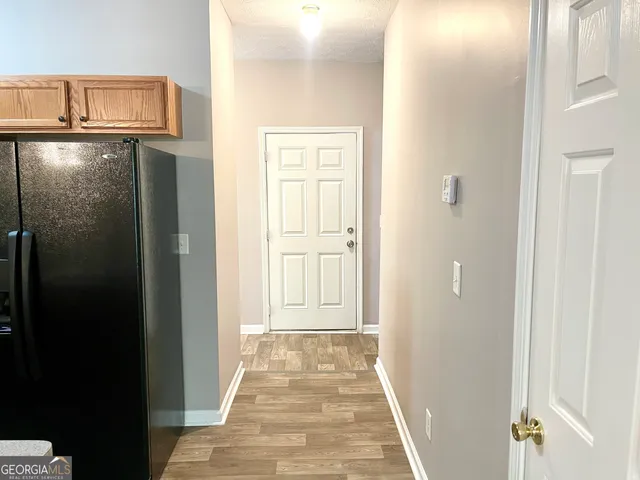 a view of a hallway with wooden floor