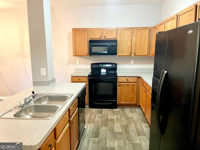 a kitchen with a sink stove and refrigerator