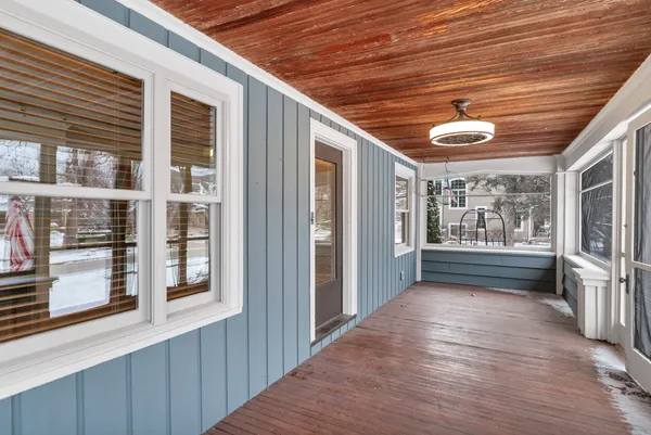 a view of porch with the front door