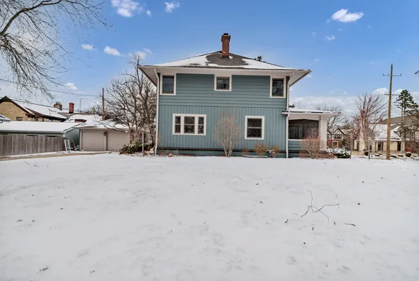 a view of a house with snow on the road