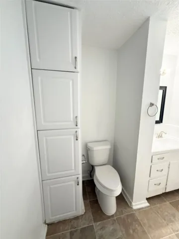 a white toilet sitting next to a bathroom sink