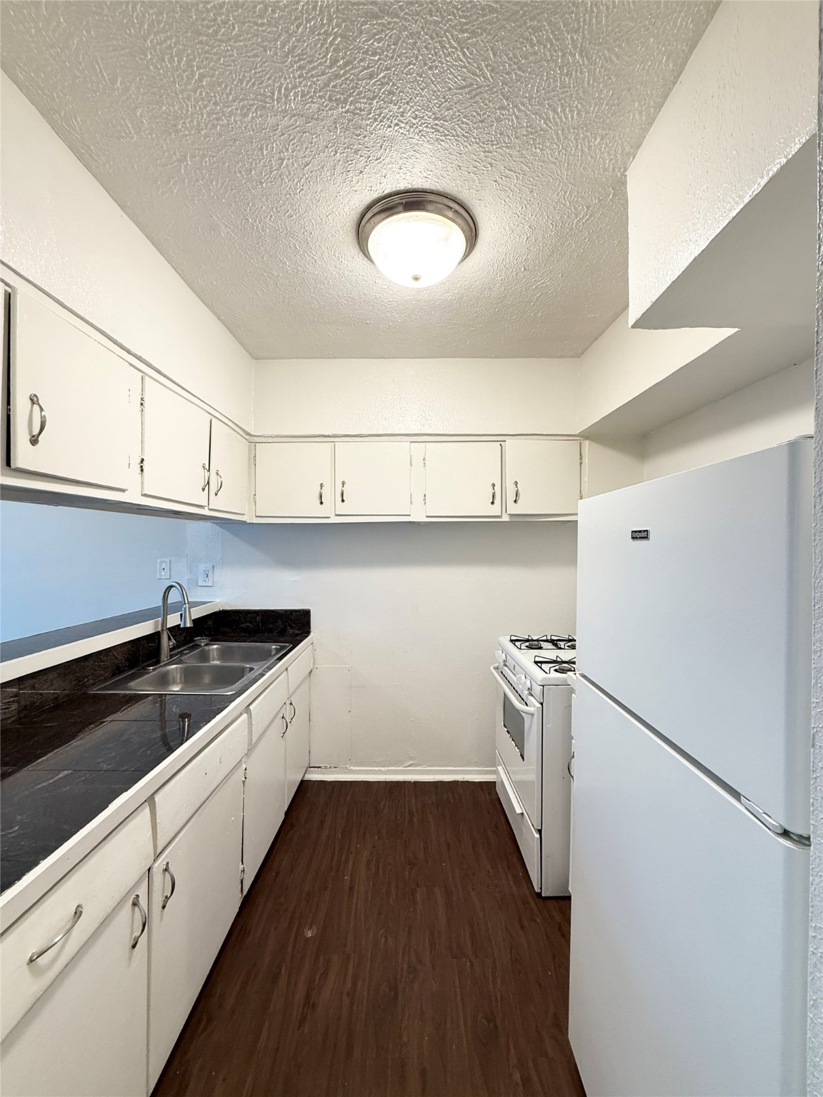 3629 North MacGregor Way, Unit 3 Houston, TX 77004 - Photo 7 of 14 a kitchen with a sink a stove and refrigerator