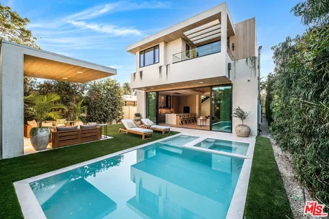 a view of a house with a backyard and a patio