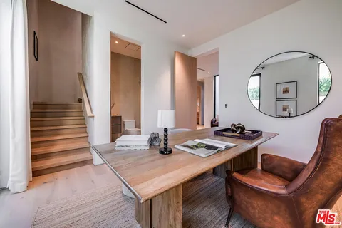 a view of a kitchen area with furniture and wooden floor