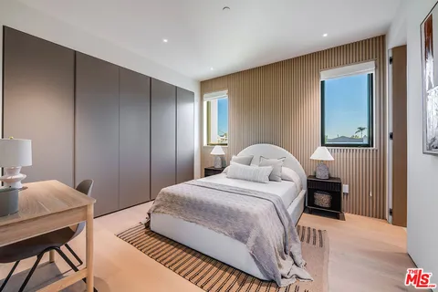 a bedroom with a bed couch and window