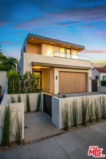 a view of an house with swimming pool and sitting area