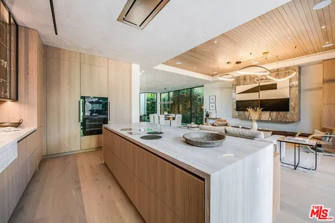 a kitchen with stainless steel appliances kitchen island granite countertop a sink and cabinets