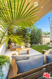 a view of backyard with swimming pool and outdoor seating