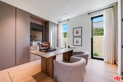 a view of a workspace with furniture and window