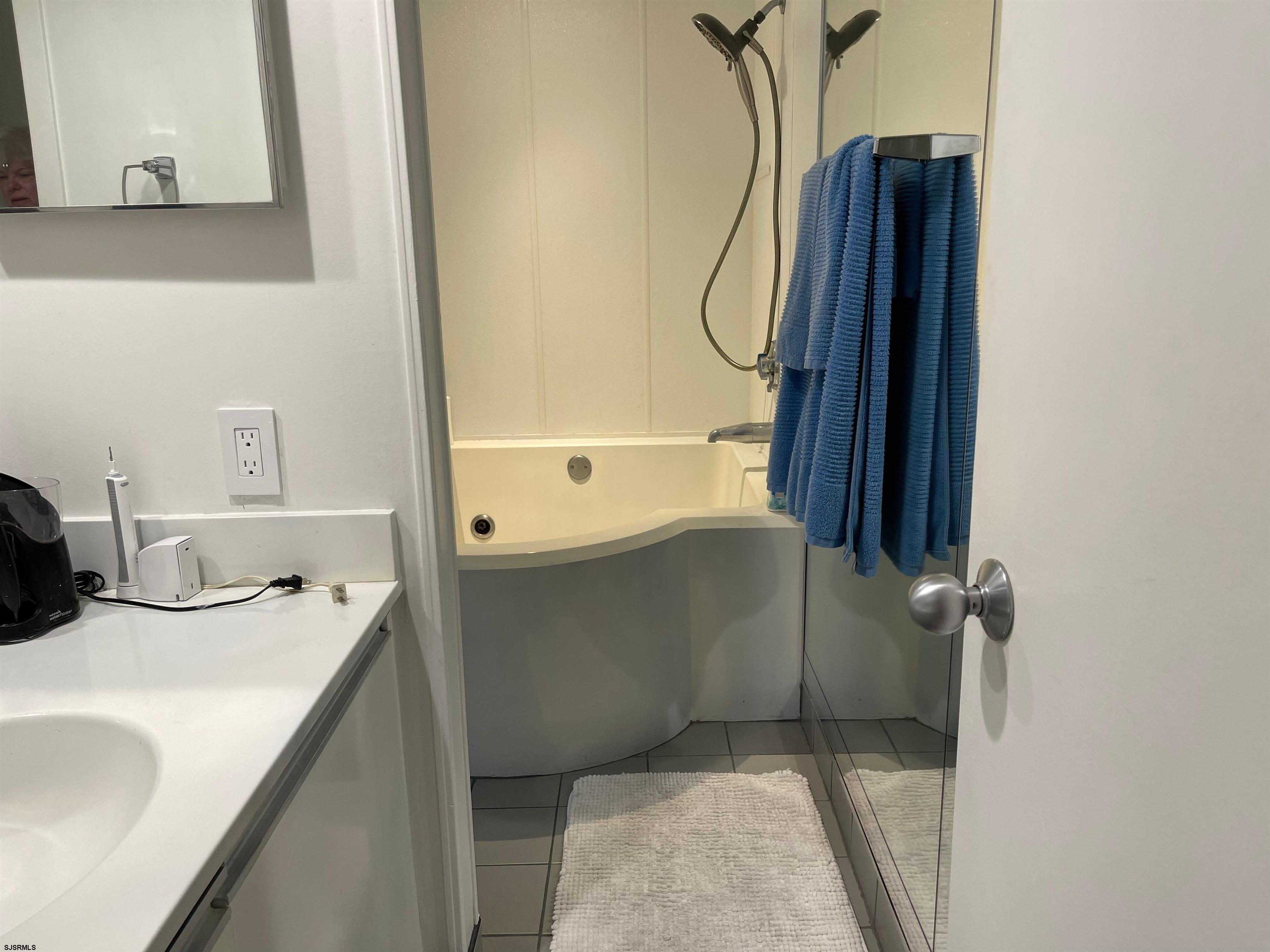 3851 Boardwalk, Unit 1405 Atlantic City, NJ 08401 - Photo 13 of 36 a bathroom with a sink and a mirror