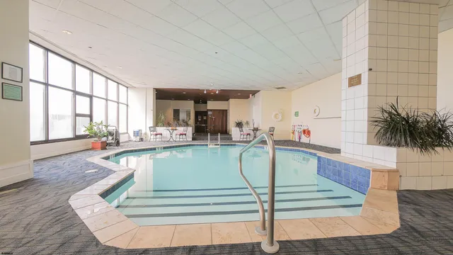 a view of a swimming pool and lounge chair