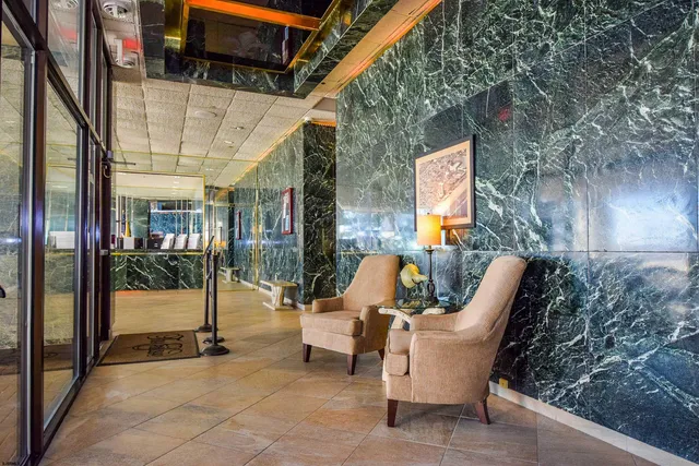 a view of a patio with a table and chairs and floor to ceiling window