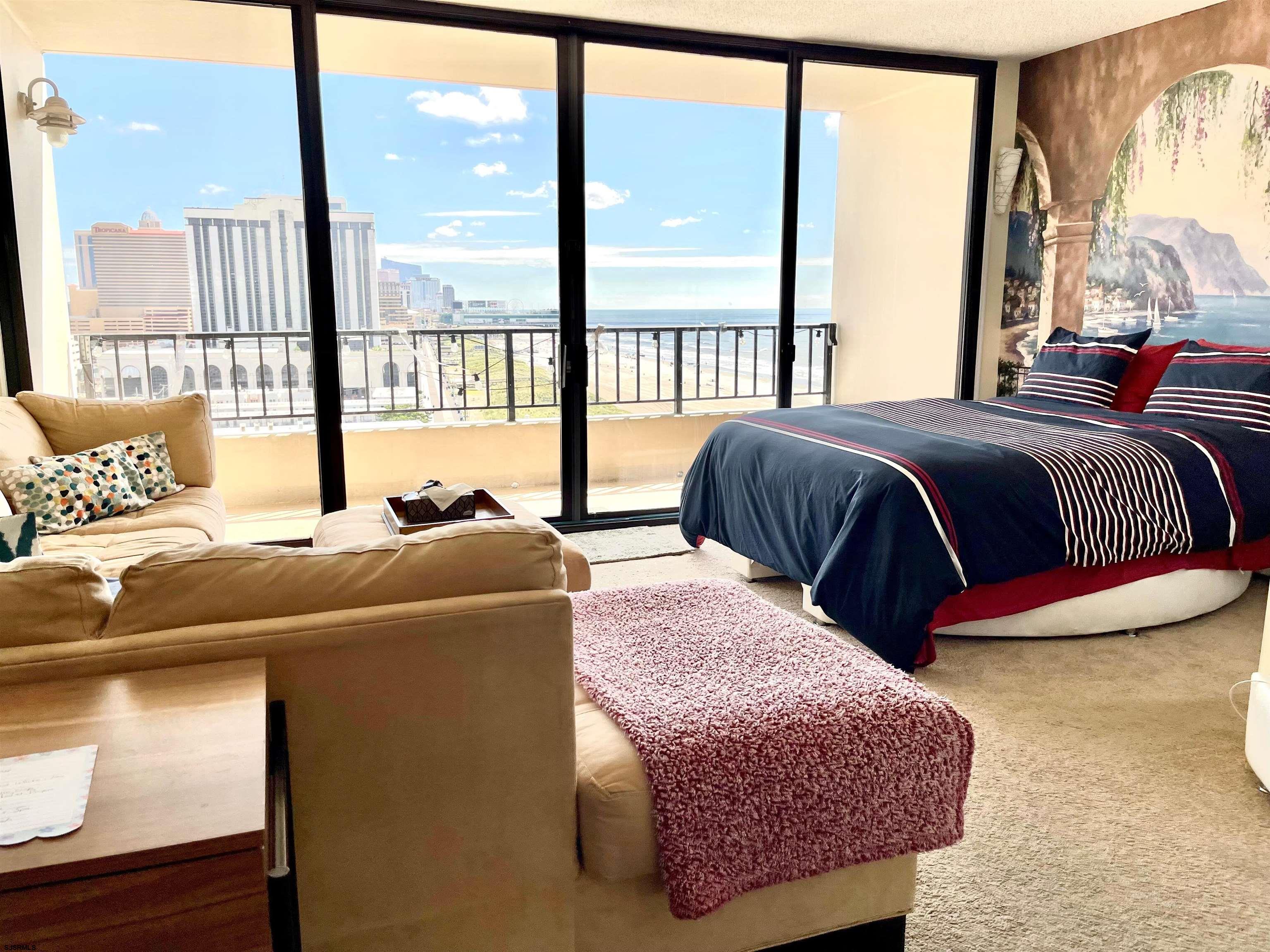 3851 Boardwalk, Unit 1405 Atlantic City, NJ 08401 - Photo 7 of 36 a bedroom with a large bed and a large window