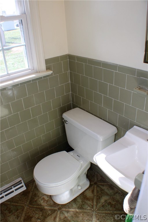 9931 Trebeck Road Chesterfield, VA 23236 - Photo 12 of 43 a white toilet sitting next to a bathroom sink