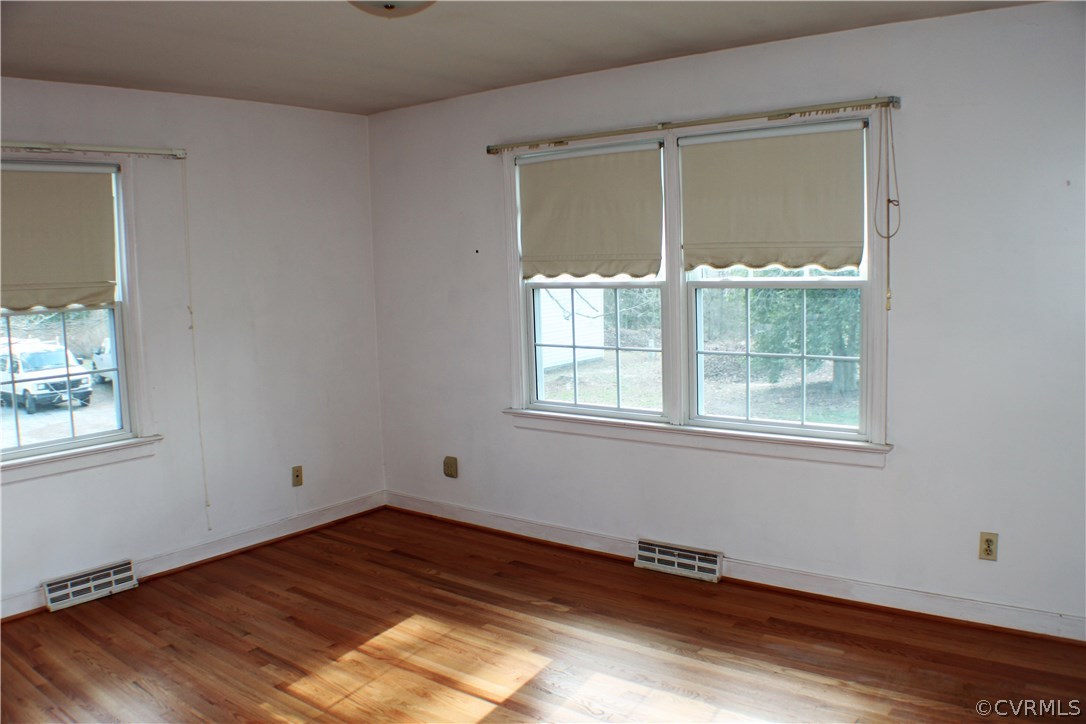 9931 Trebeck Road Chesterfield, VA 23236 - Photo 22 of 43 an empty room with wooden floor and windows