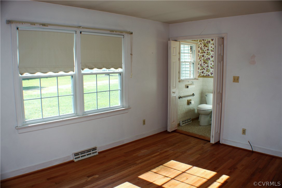9931 Trebeck Road Chesterfield, VA 23236 - Photo 25 of 43 an empty room with a window and wooden floor
