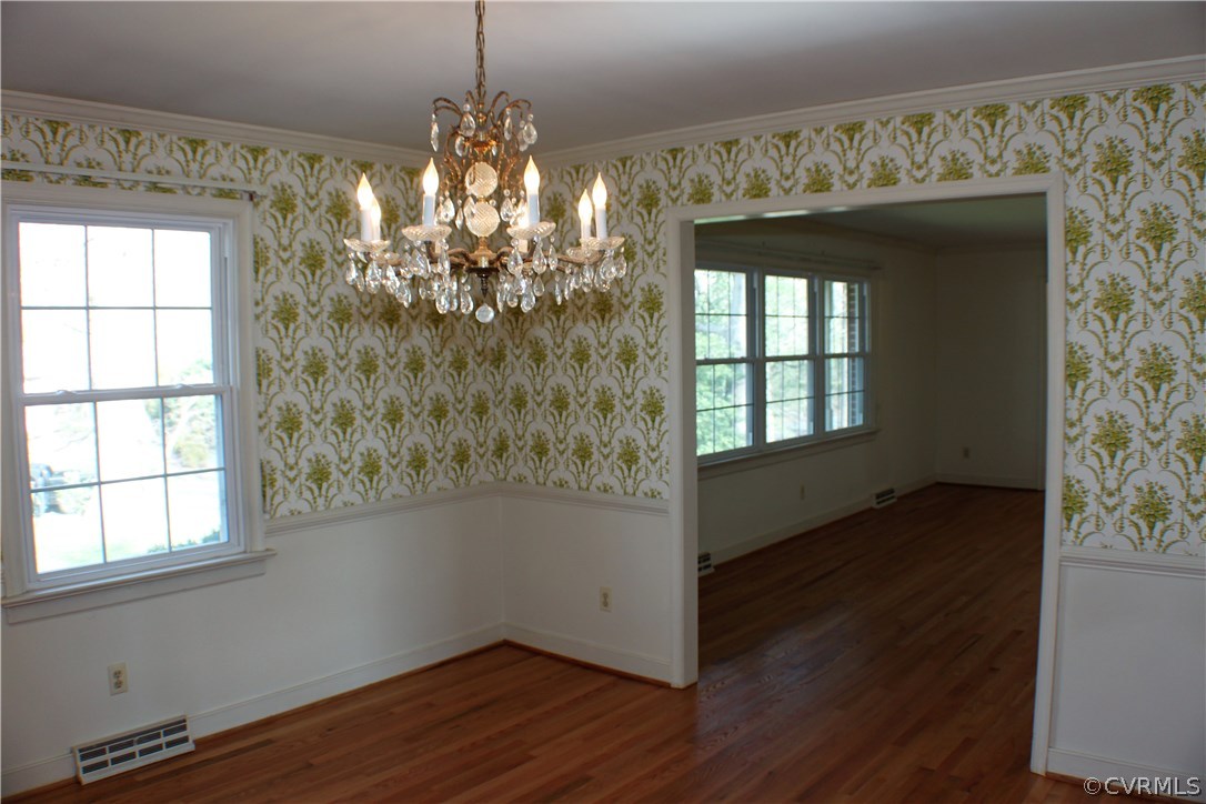 9931 Trebeck Road Chesterfield, VA 23236 - Photo 6 of 43 a room with wooden floor chandelier and windows