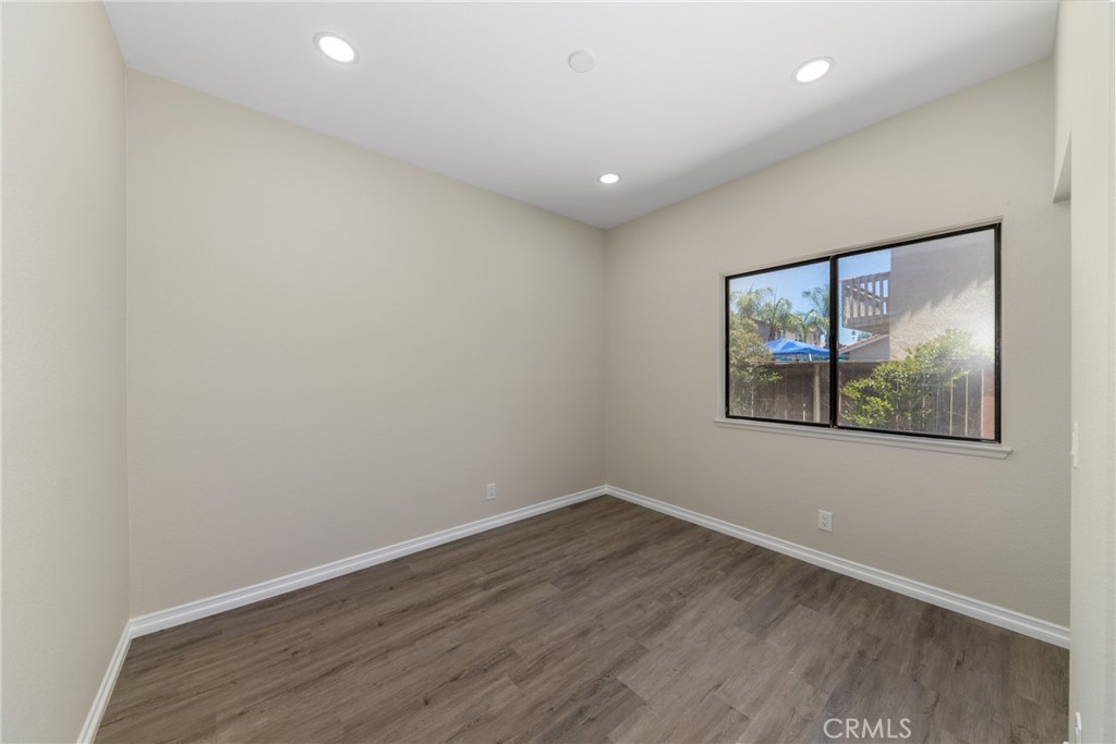 32465 Cape Cod Drive Lake Elsinore, CA 92530 - Photo 13 of 29 an empty room with wooden floor and window
