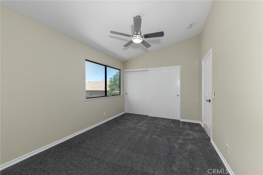 32465 Cape Cod Drive Lake Elsinore, CA 92530 - Photo 20 of 29 an empty room with windows and fan