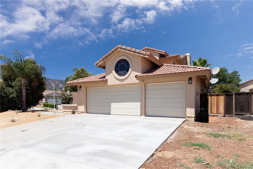 32465 Cape Cod Drive Lake Elsinore, CA 92530 - Photo 3 of 29 a front view of a house with a yard